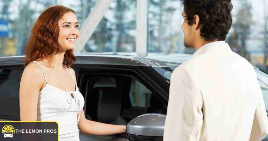 Seller handing vehicle paperwork containing the VIN to a buyer